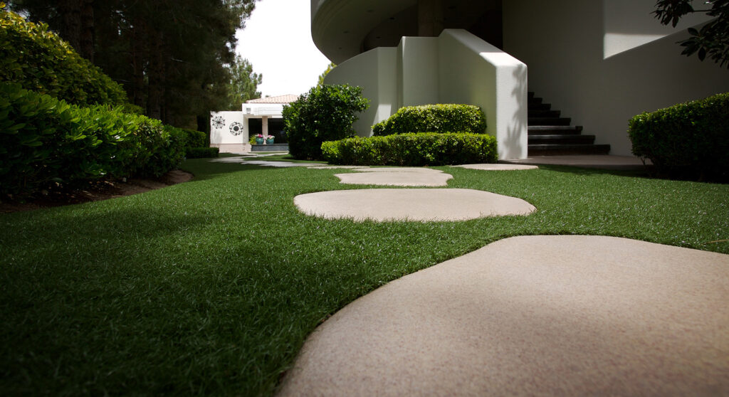 Residential Artificial Grass by SYNLawn Oahu and walkway pavers leading to home in Honolulu, enhancing curb appeal.
